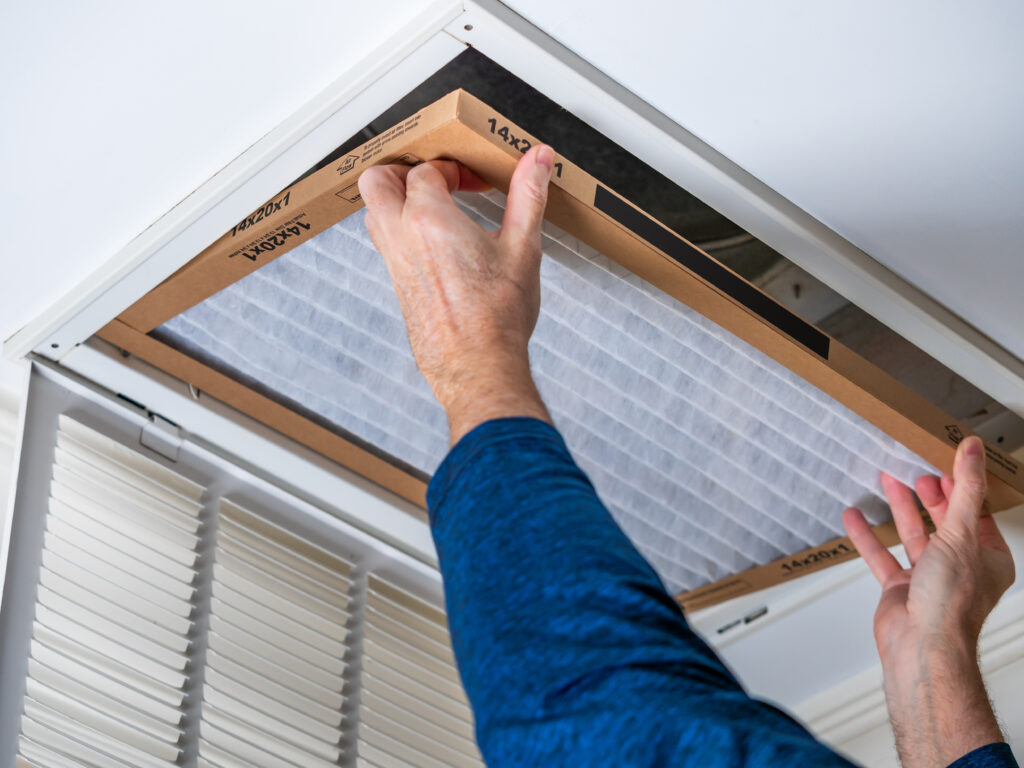 HVAC technician replacing a home air filter in San Francisco