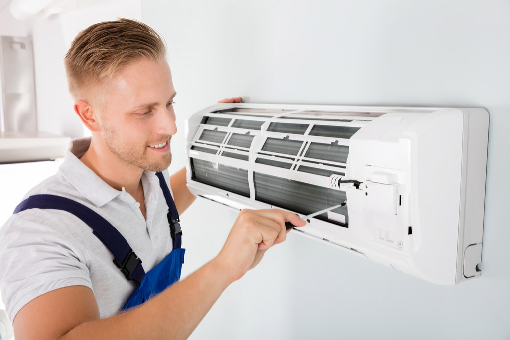 HVAC technician maintaining a ductless air conditioner in San Francisco