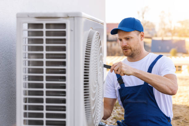 HVAC technician servicing an outdoor air conditioner in San Francisco